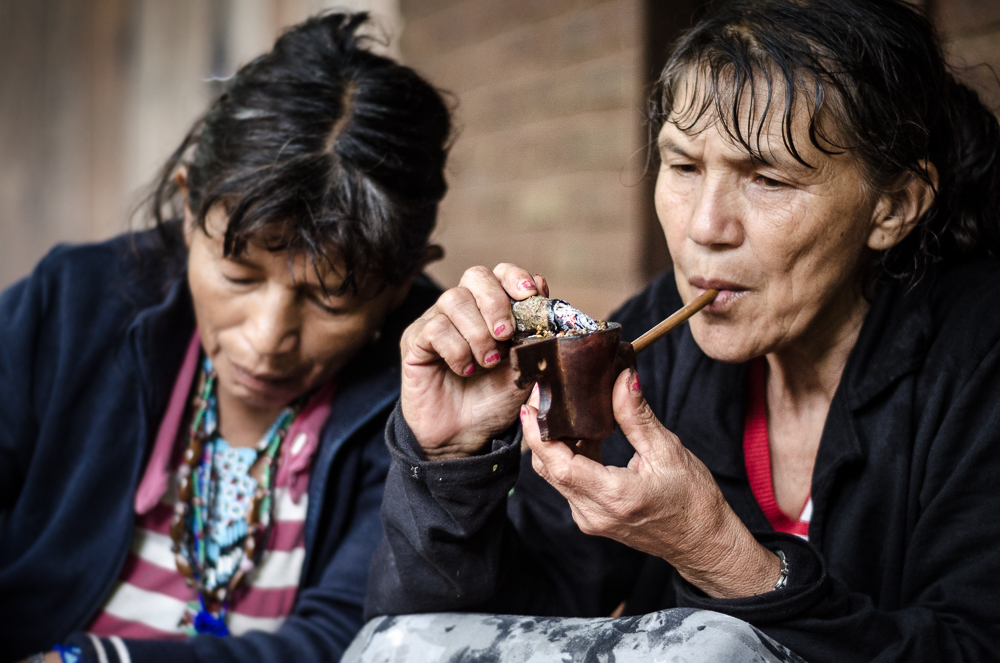Guarani tribe craftswomen smokes tobacco, known in Brasil as 